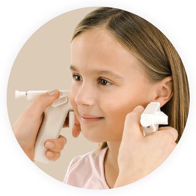 Person receiving an ear piercing with a piercing gun, close-up, indoors.