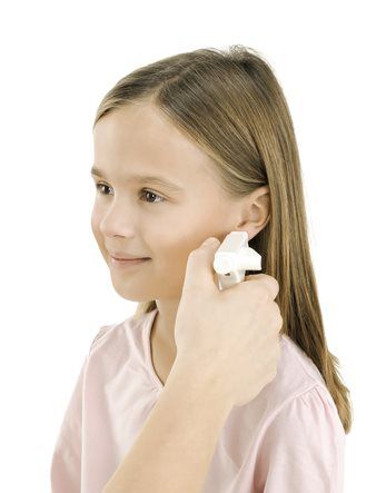 Girl using ear thermometer.