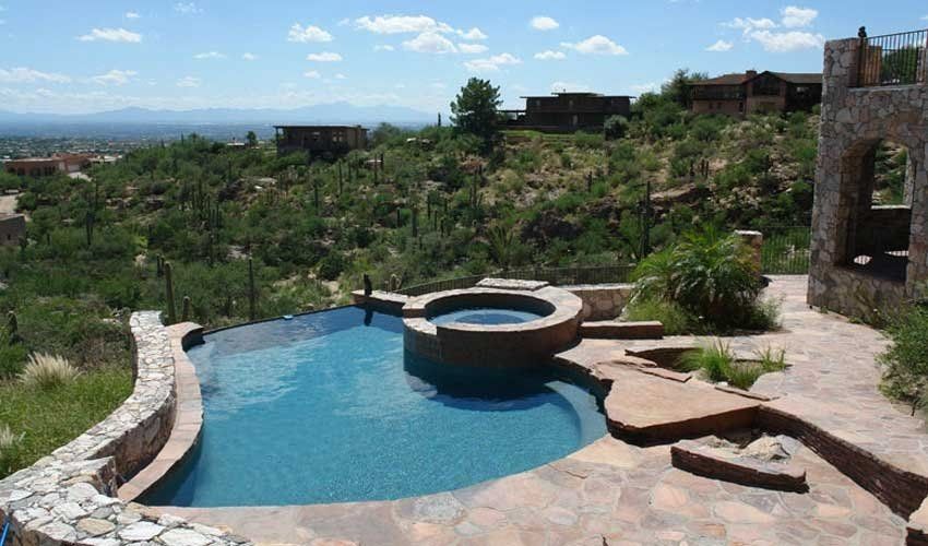 A large swimming pool with a hot tub in the middle