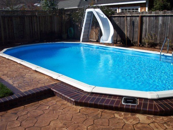 A large swimming pool with a slide attached to it