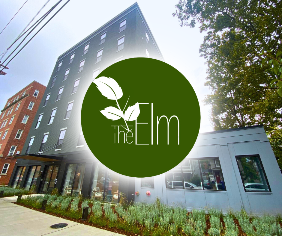 A picture of a building with a green logo that says the elm