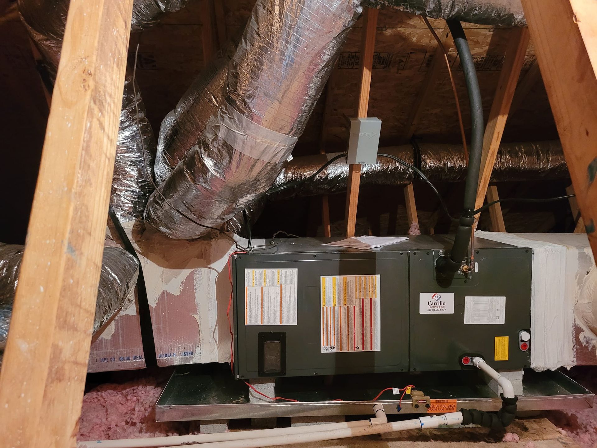 An air conditioner is installed in the attic of a house.