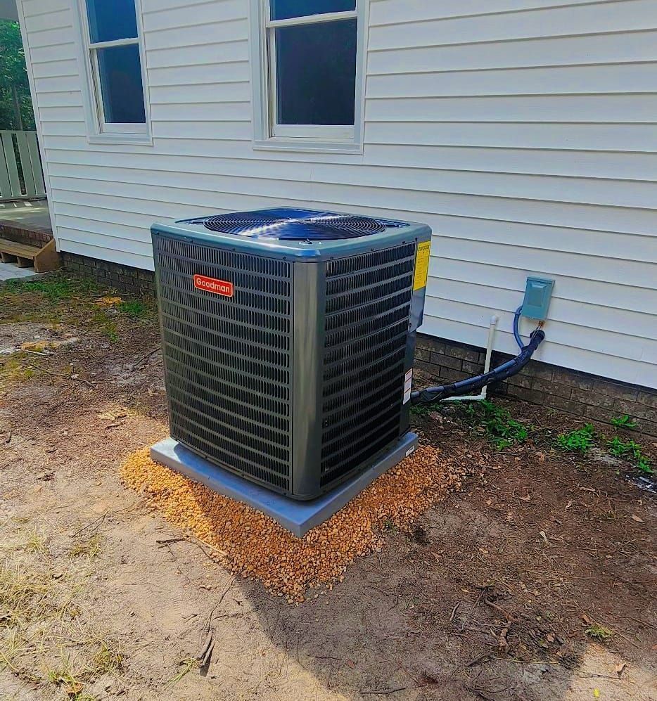A large air conditioner is sitting outside of a house.