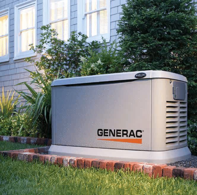A generator is sitting in the grass in front of a house