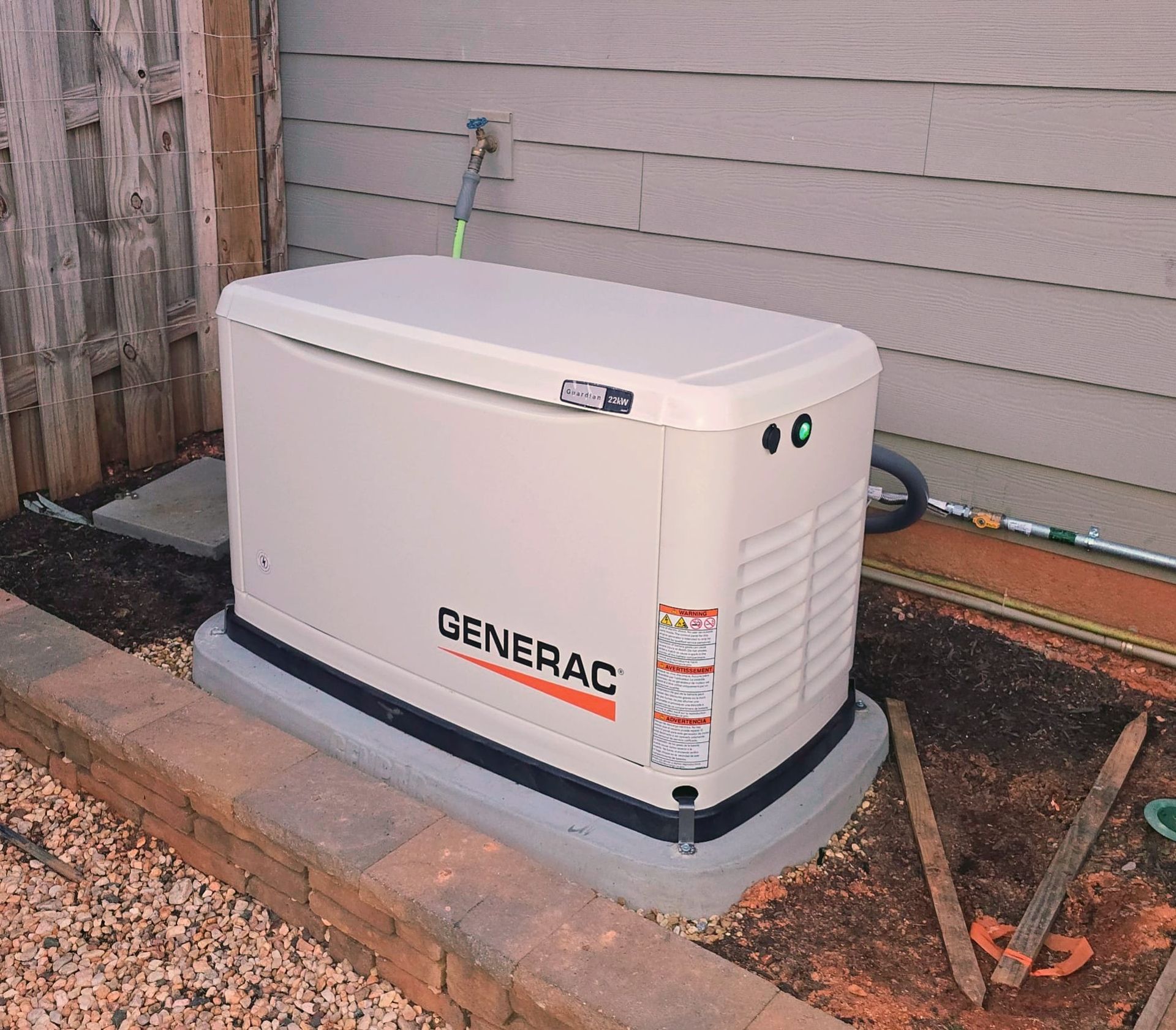 A generac generator is sitting outside of a house