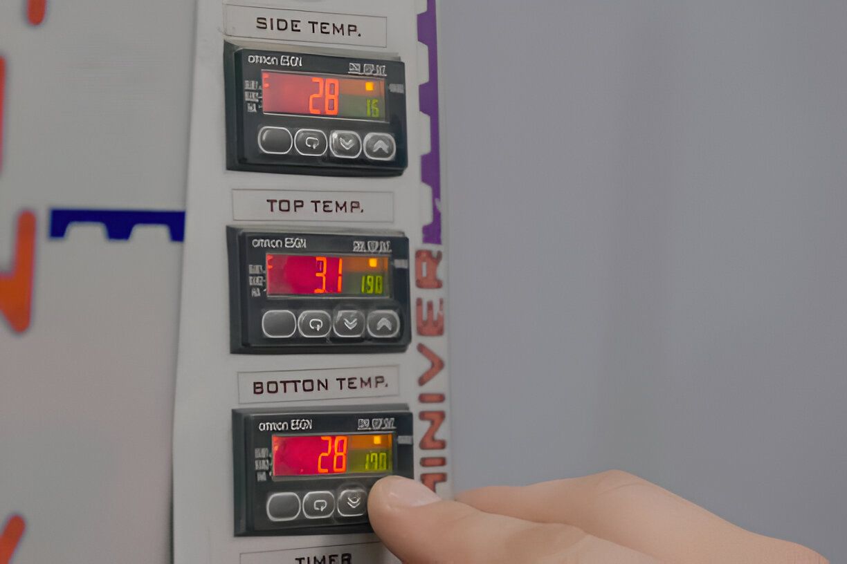 A person is adjusting the temperature of a machine