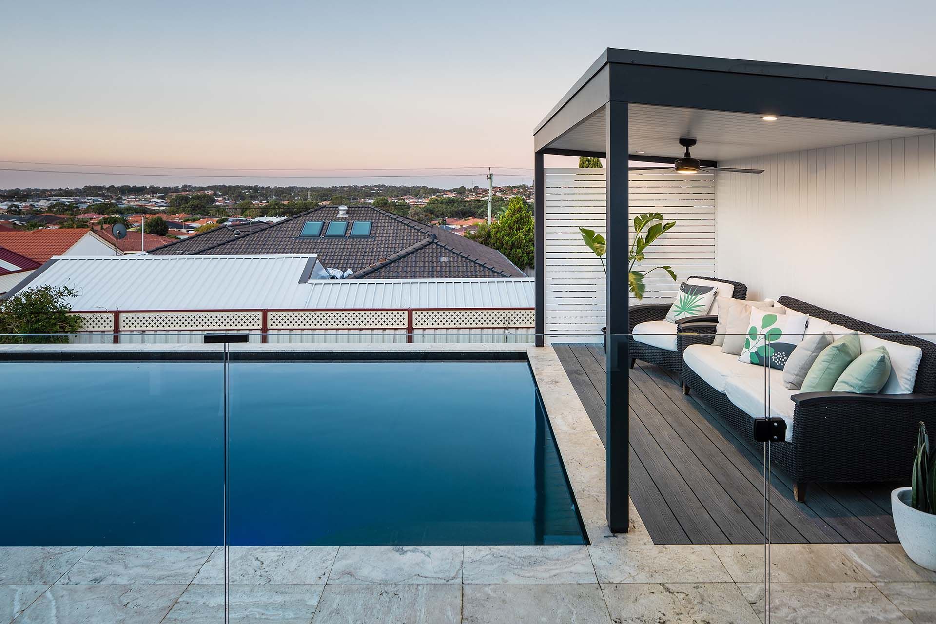 There is a swimming pool on the roof of a house.