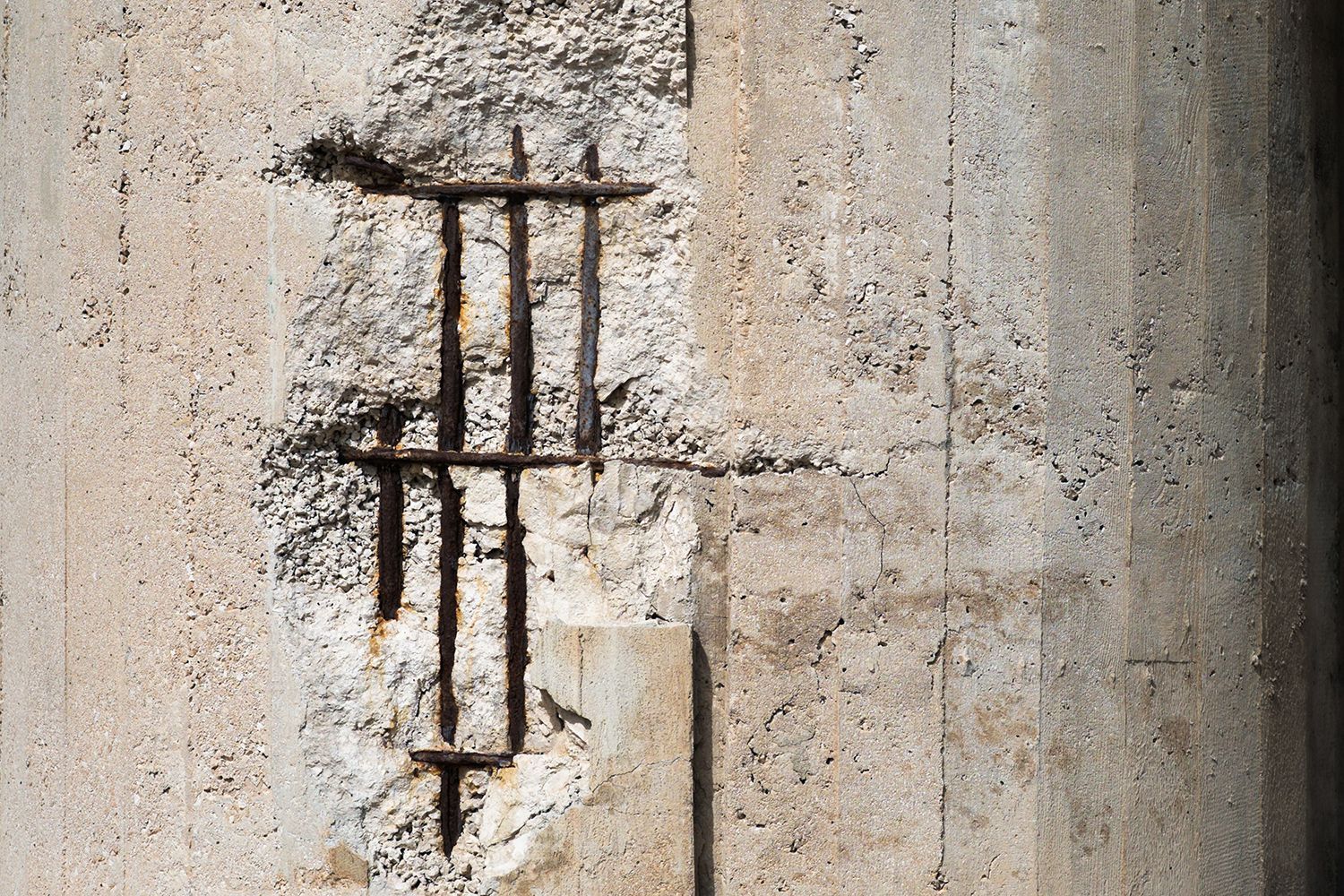 concrete wall with exposed steel bars