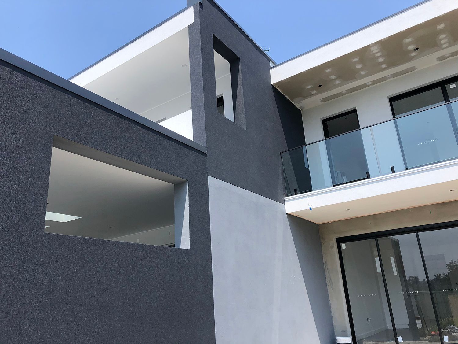 A large house with a balcony and sliding glass doors