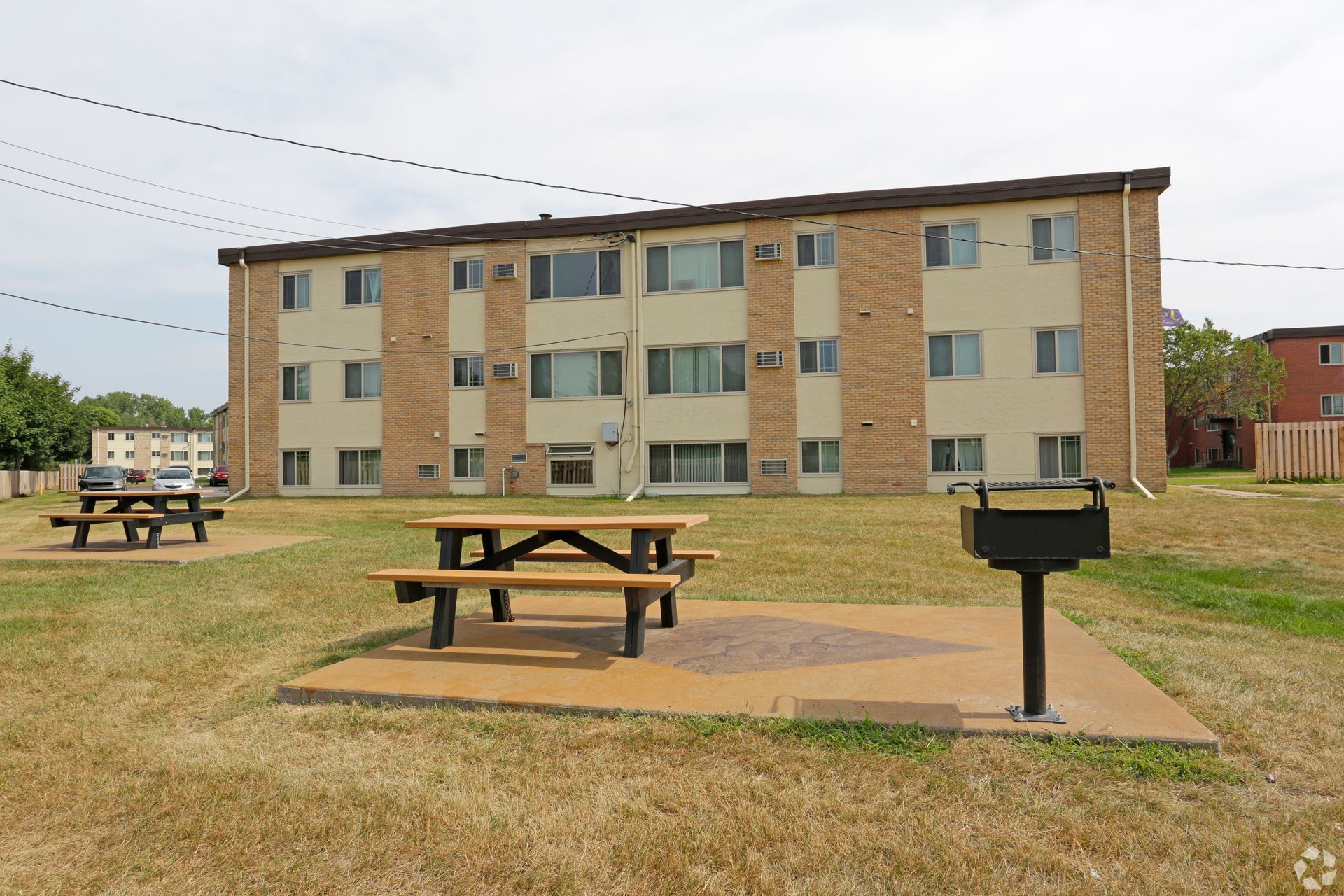 A building with a picnic area in front of it