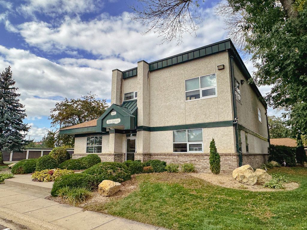 A large building with a lot of windows and a green roof