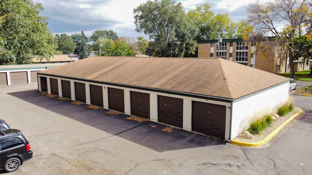 An aerial view of a parking garage with a car parked in front of it.