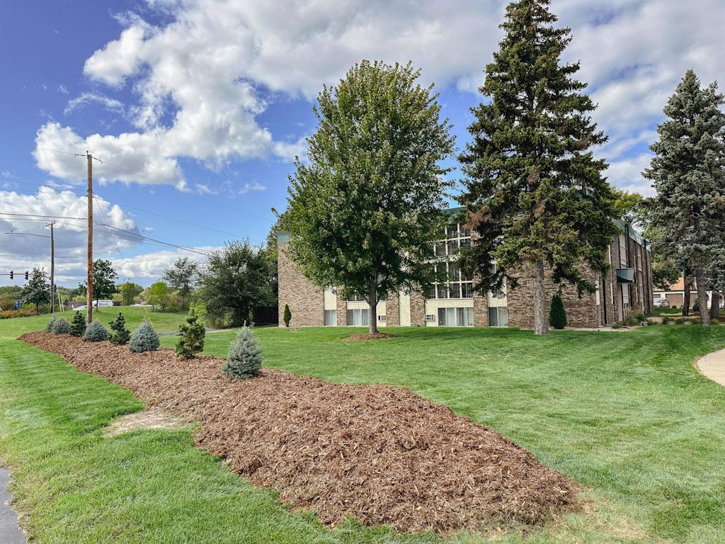 A large house with a lot of trees in front of it