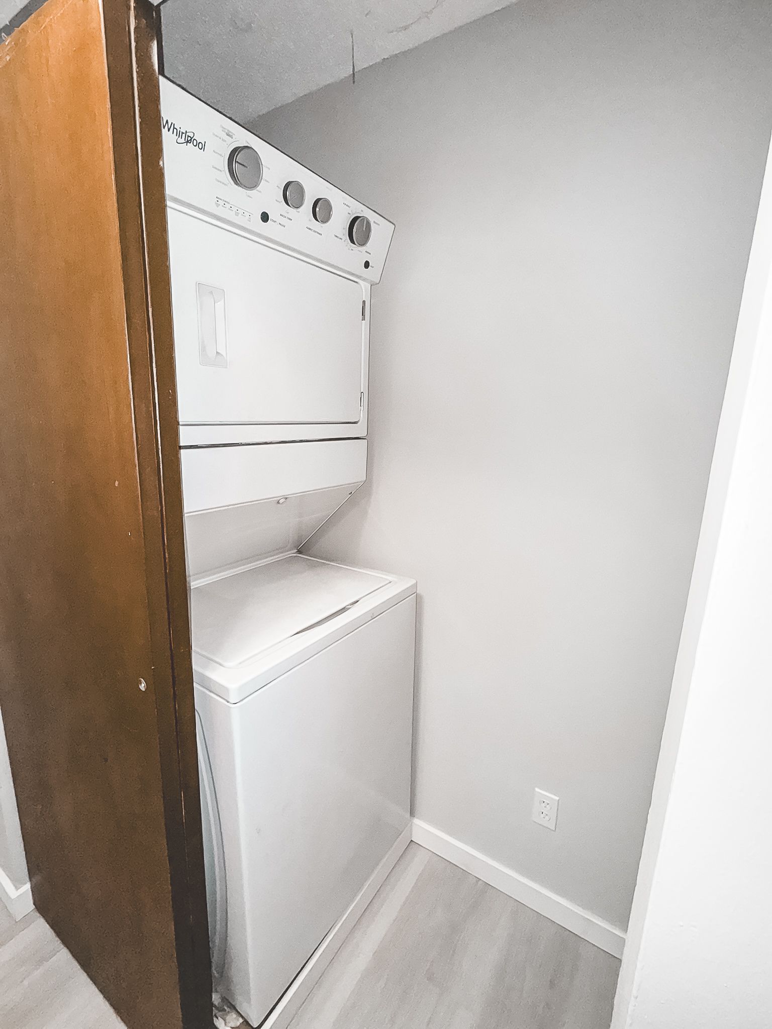 A washer and dryer are stacked on top of each other in a laundry room.