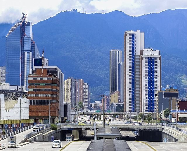 A city with a lot of buildings and mountains in the background