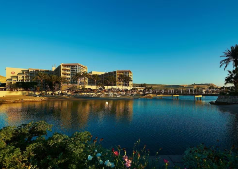 A large body of water with buildings in the background