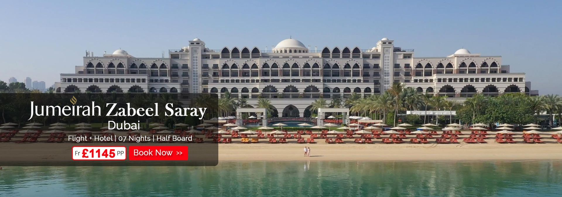 A large building with a beach in front of it