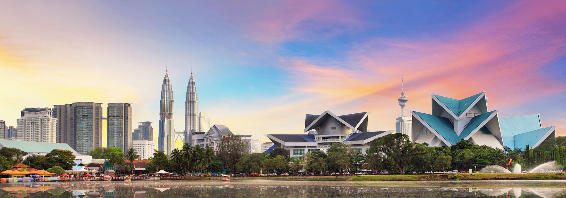 Sunset view of Kuala Lumpur from across a small river in Malaysia.