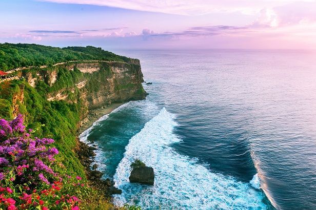 An ocean sunset view from Uluwatu Temple, a Hindu temple in Bali, Indonesia.