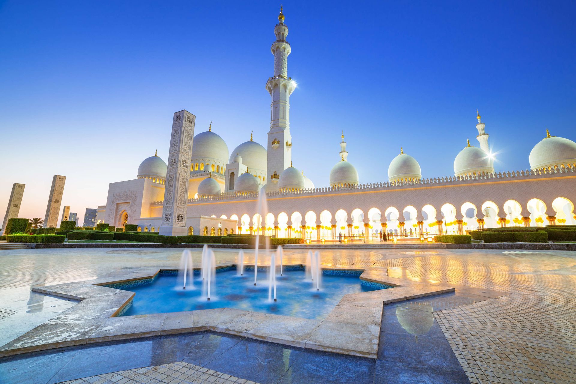 A mosque with a fountain in front of it