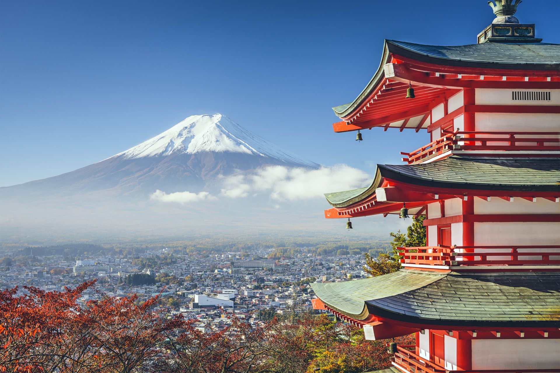 A traditional Japanese building with Mount Fuji, a mountain peak in Tokyo, Japan in the background.