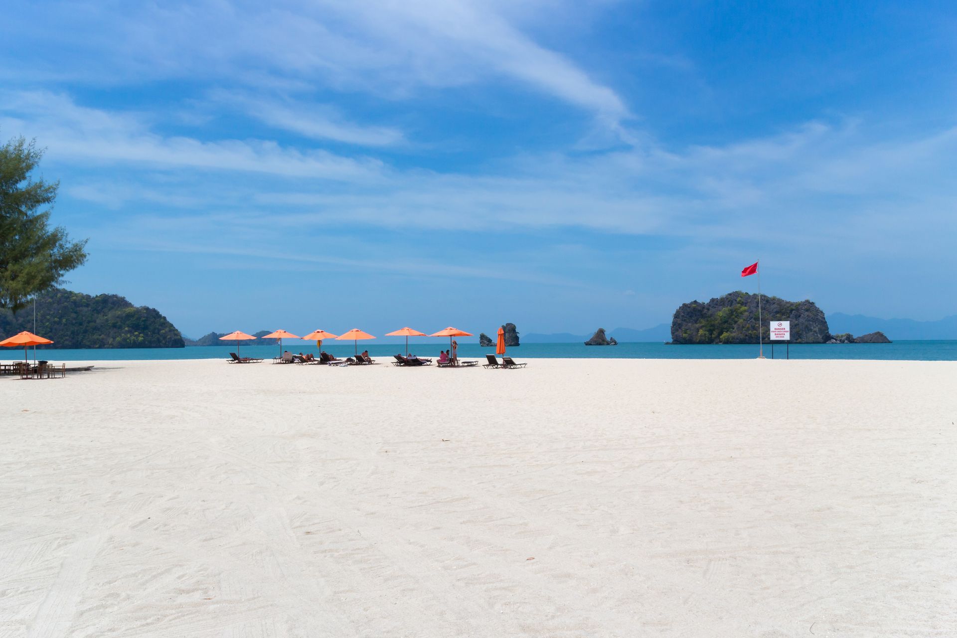 Tourists enjoying the view in Tanjung Rhu Beach in Langkawi on their Malaysia holidays.