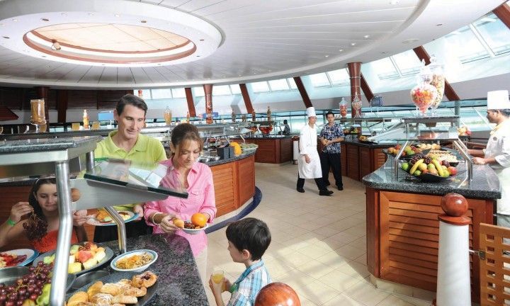 A family is eating at a buffet on a cruise ship.