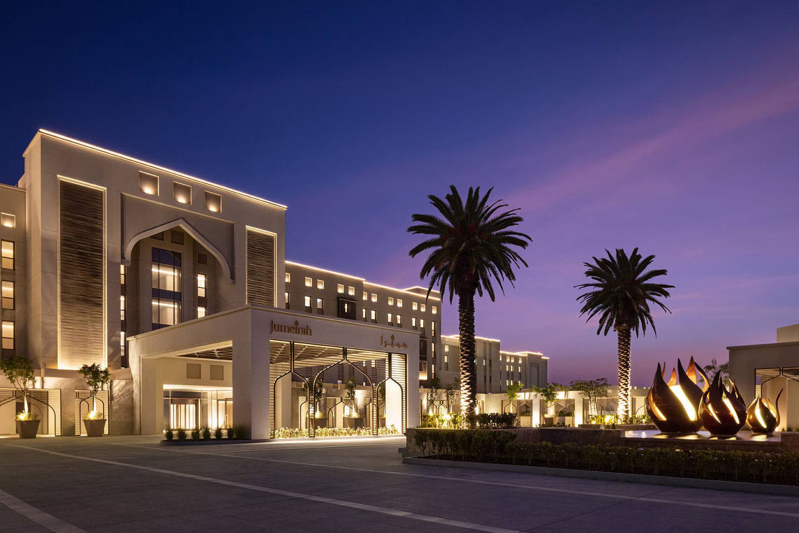 A large building with palm trees in front of it