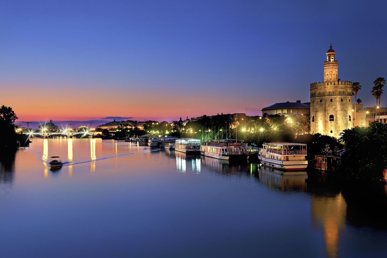 Night view of Torre Del Oro, a tower in Seville, Spain.