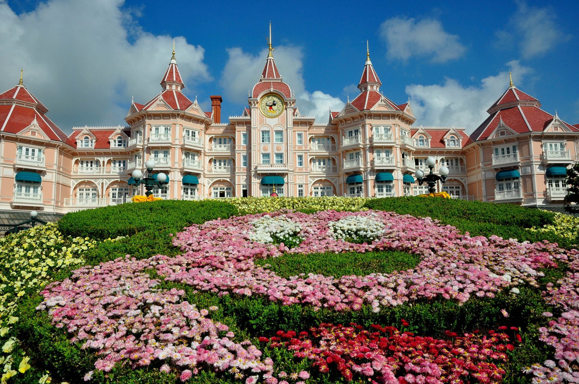 A large building with flowers in front of it