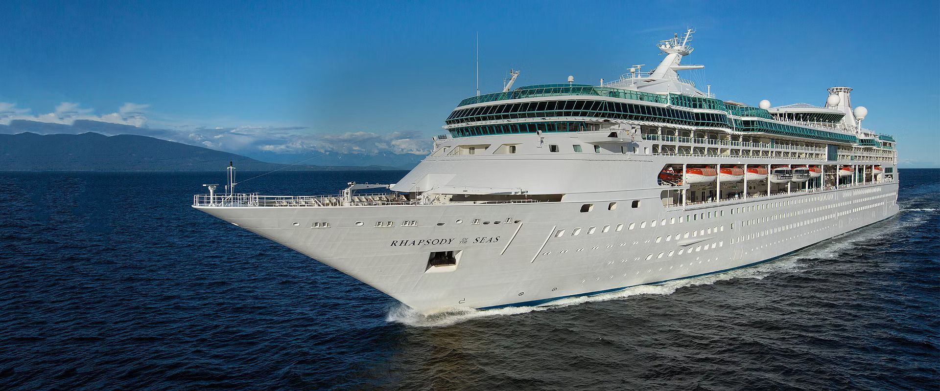 A large cruise ship is floating on top of a body of water.