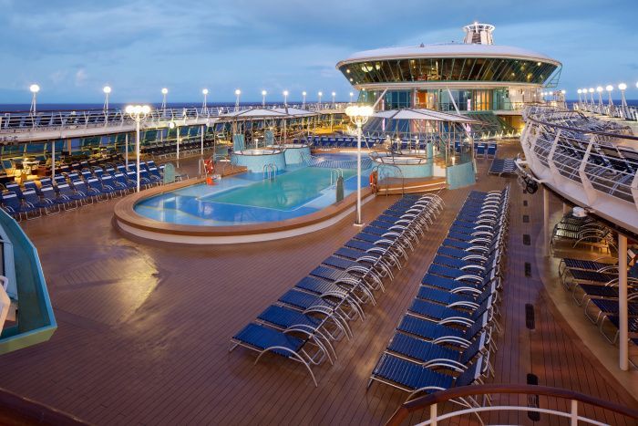A large cruise ship with a swimming pool and a slide