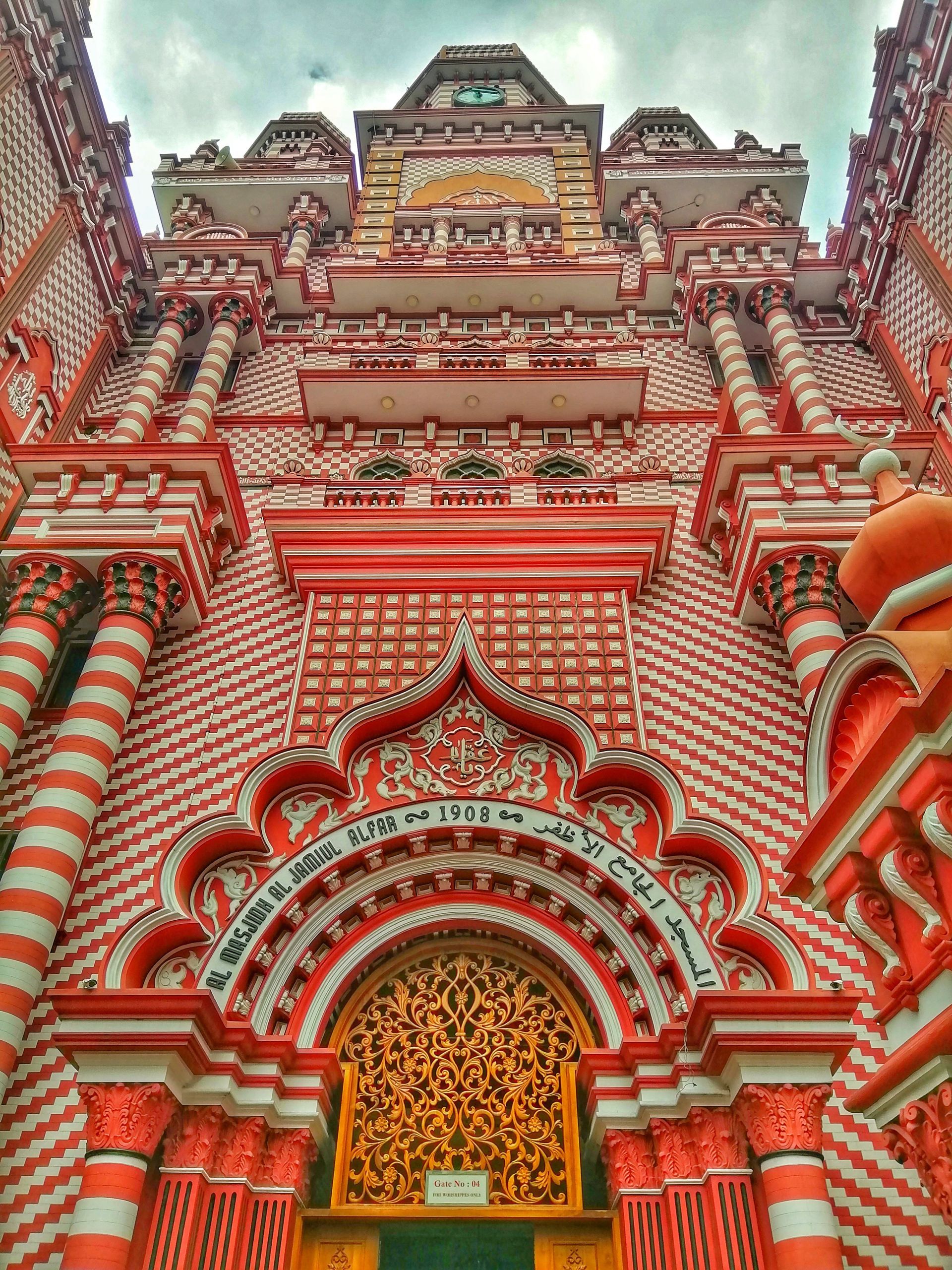 Looking up at the front of a red and white brick building.