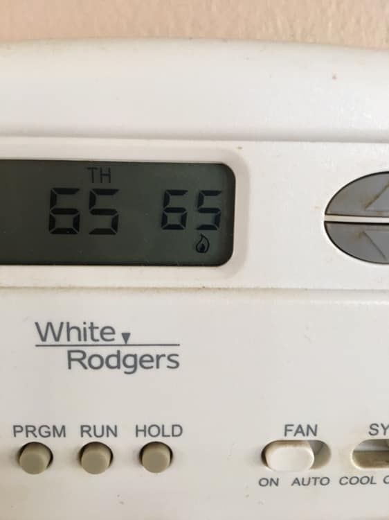White-Rodgers thermostat showing current and set temperatures of 65 degrees. The 