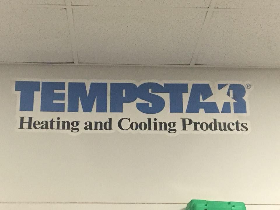 Tempstar Heating and Cooling Products logo on a white wall.