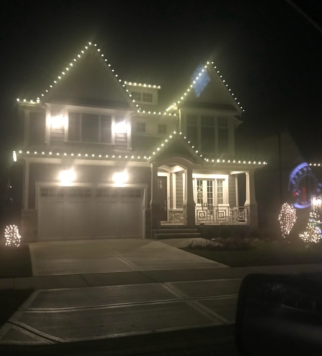 A house is lit up with christmas lights at night