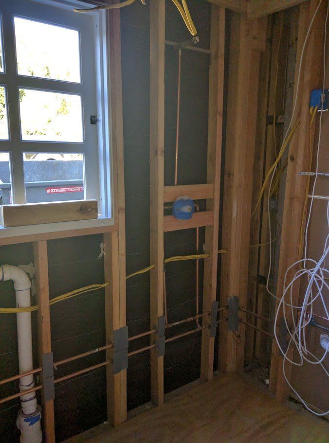 A room with a window and a lot of wires on the wall