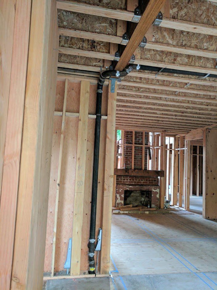 A house is being built with a fireplace in the middle of the room.