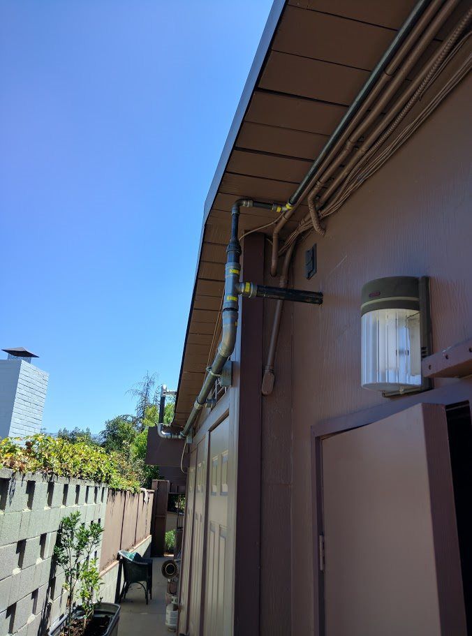 A building with a light on the side of it and a blue sky in the background.