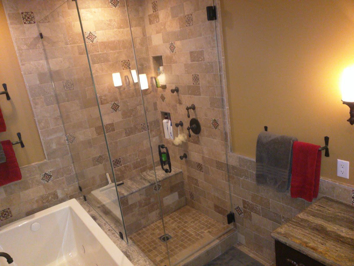 A bathroom with a walk in shower and a bathtub.