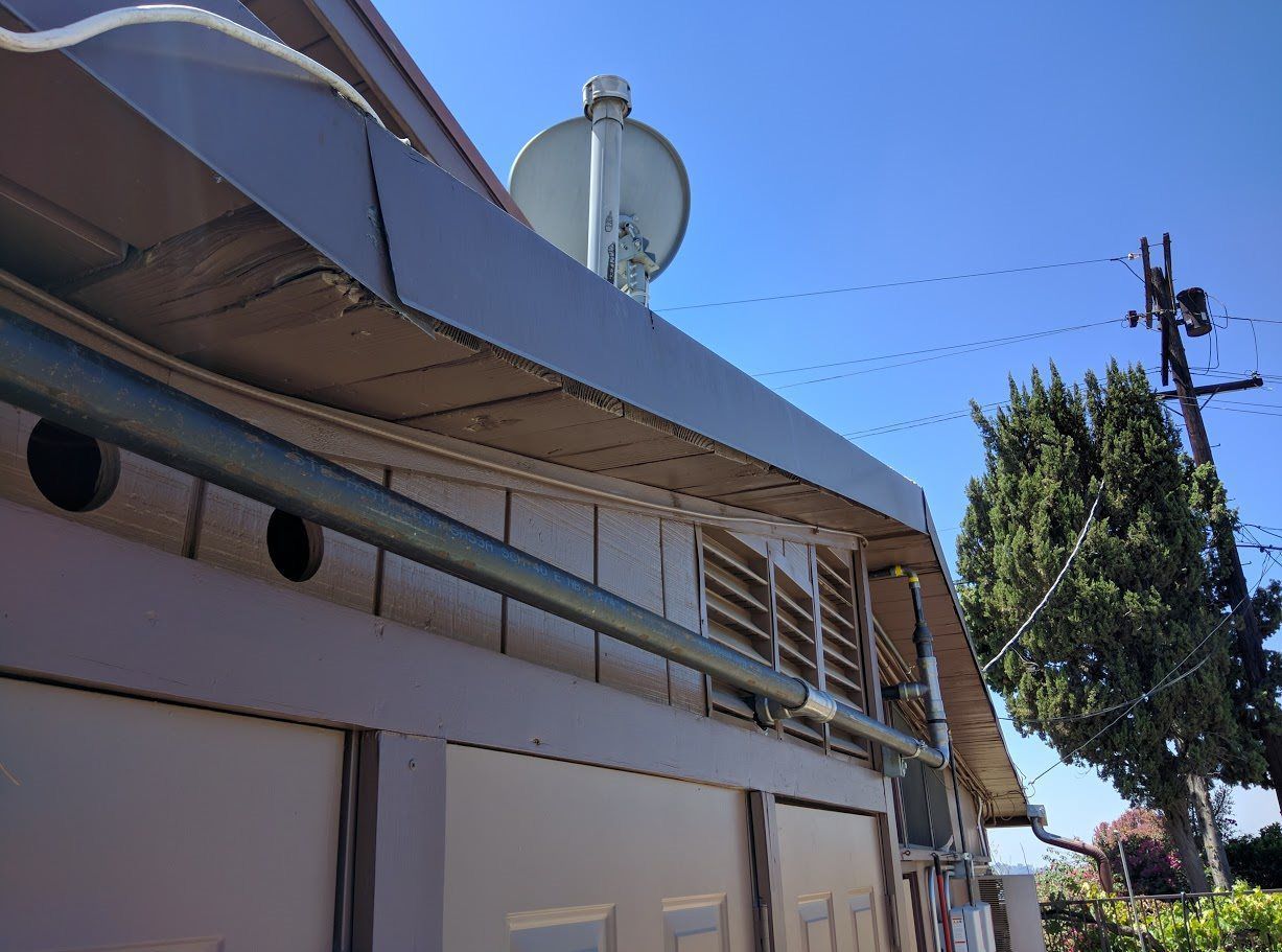 A house with a satellite dish on top of it.