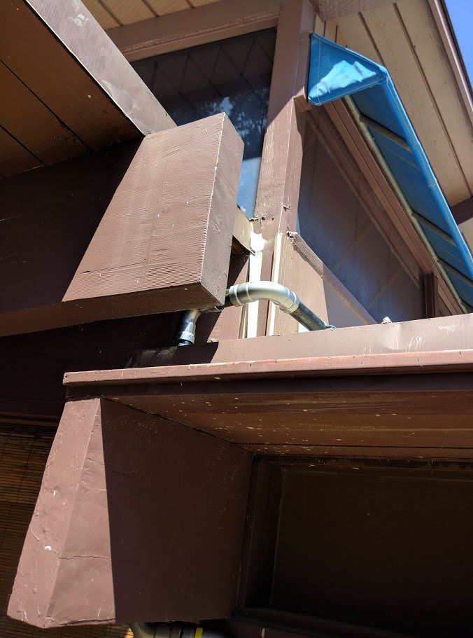 A blue awning is hanging from the side of a building