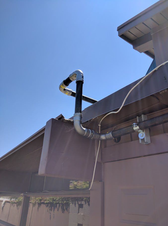 A pipe is attached to the side of a building