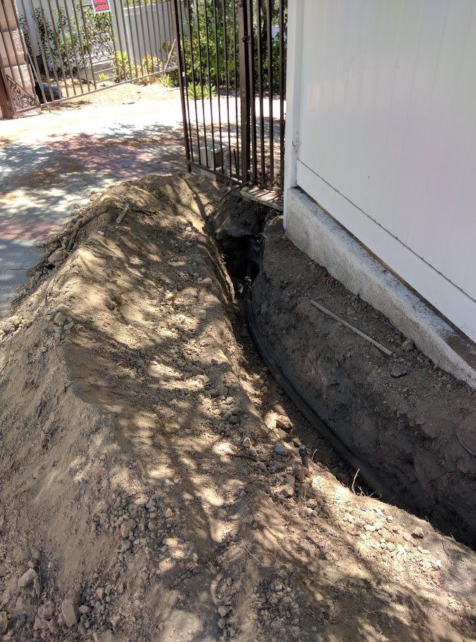 A large pile of dirt is sitting next to a house.