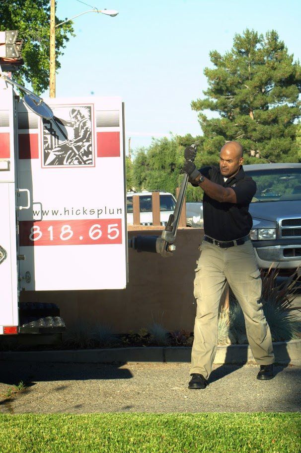 A man is standing in front of an ambulance with the number 318-65 on it