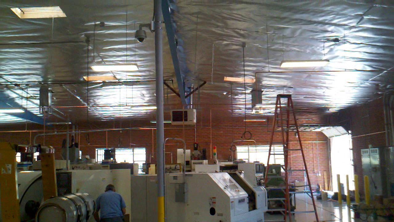 A factory with a lot of machinery and a ladder