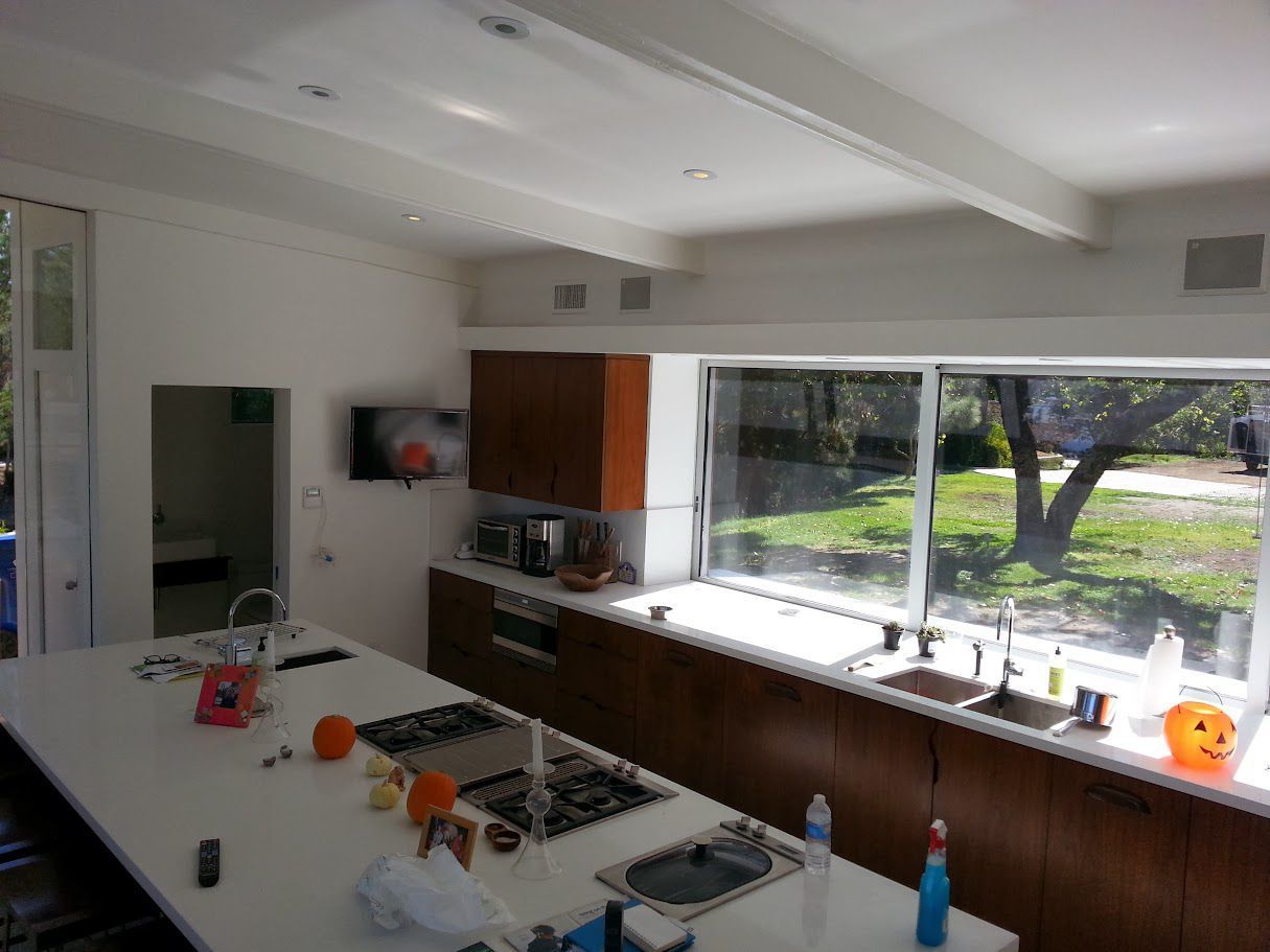 A kitchen with a large island and a large window