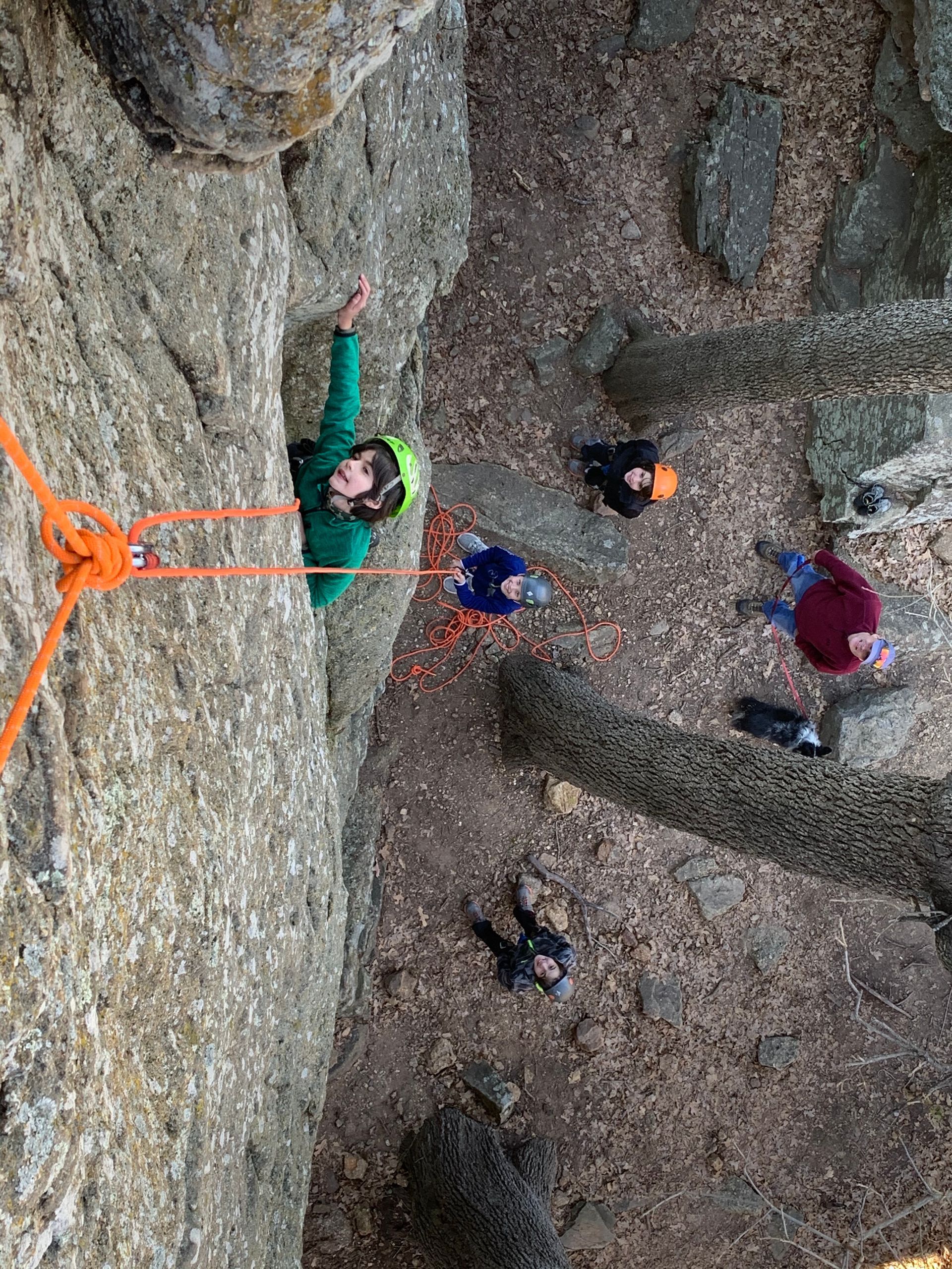 A group of people are climbing a rock wall.