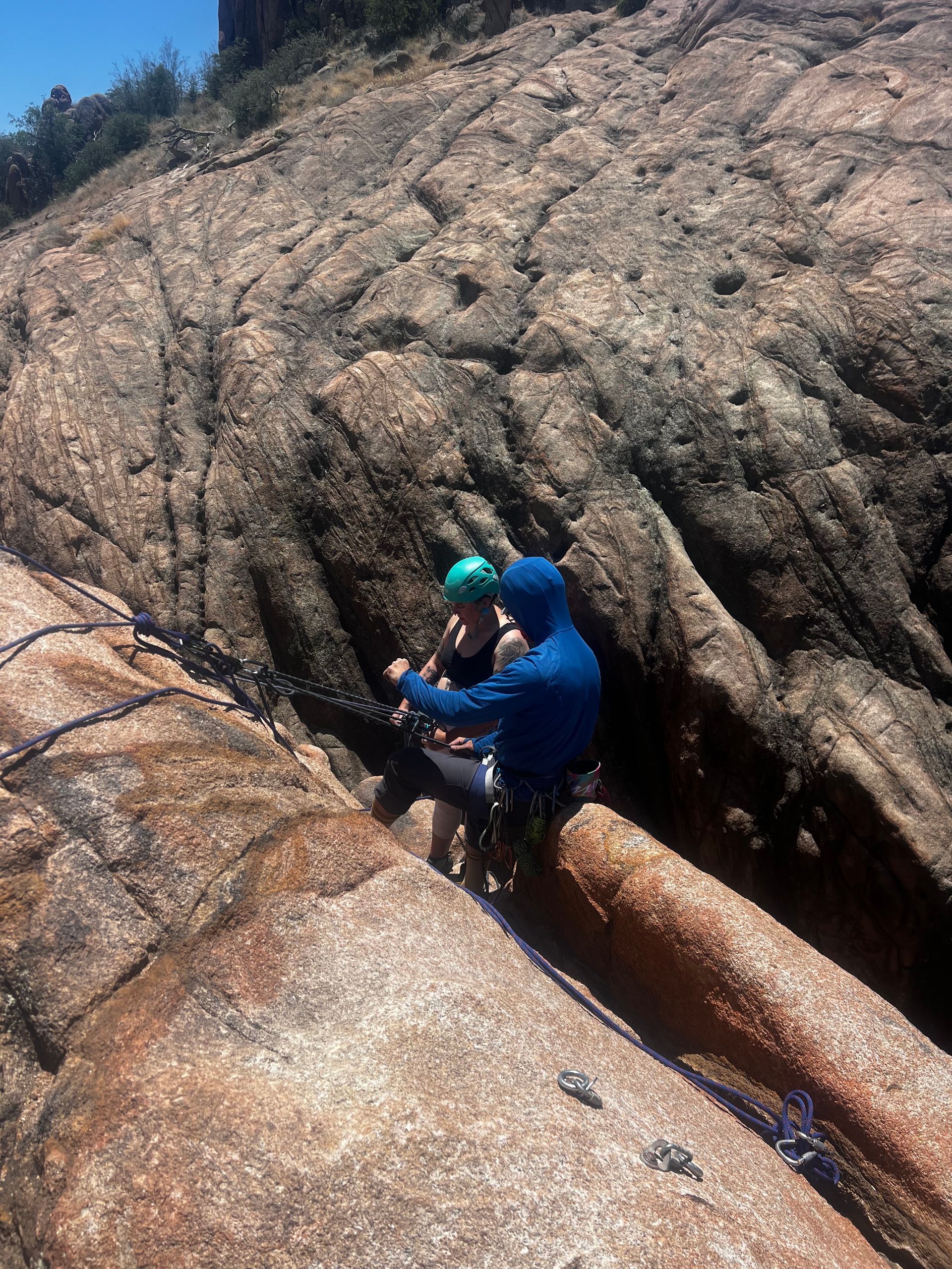 2 people standing on rocks learning how to rock climb