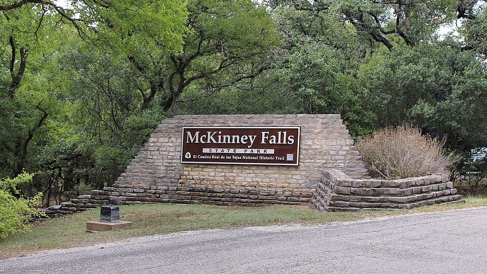 Climber on limestone boulder at McKinney Falls State Park